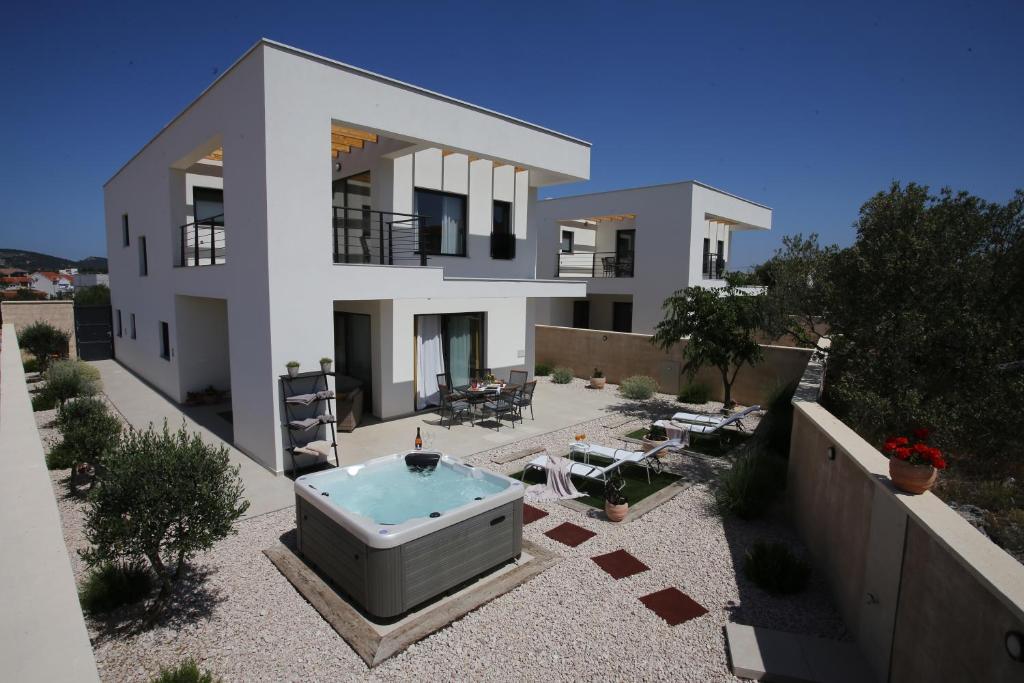 a house with a hot tub in front of it at Elegant Villa Punta Sol with hot tube, walk to sea and center in Jezera