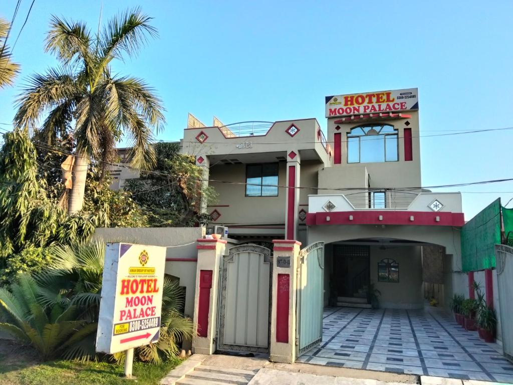 a house with a sign in front of it at Moon Palace Hotel Lahore in Lahore