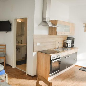 a small kitchen with a stove and a sink at Monte Baldo in Ilmmünster