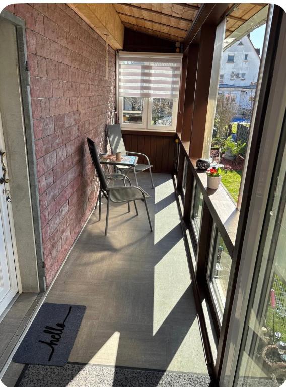 a balcony with a table and chairs on a brick wall at Top location central in Rüsselsheim