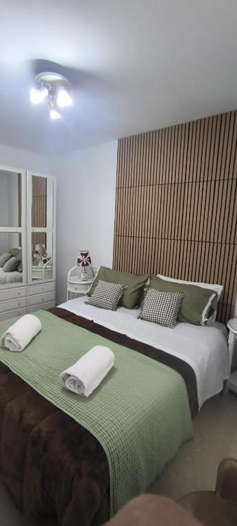 a bedroom with a large bed with towels on it at Salvora in Bueu