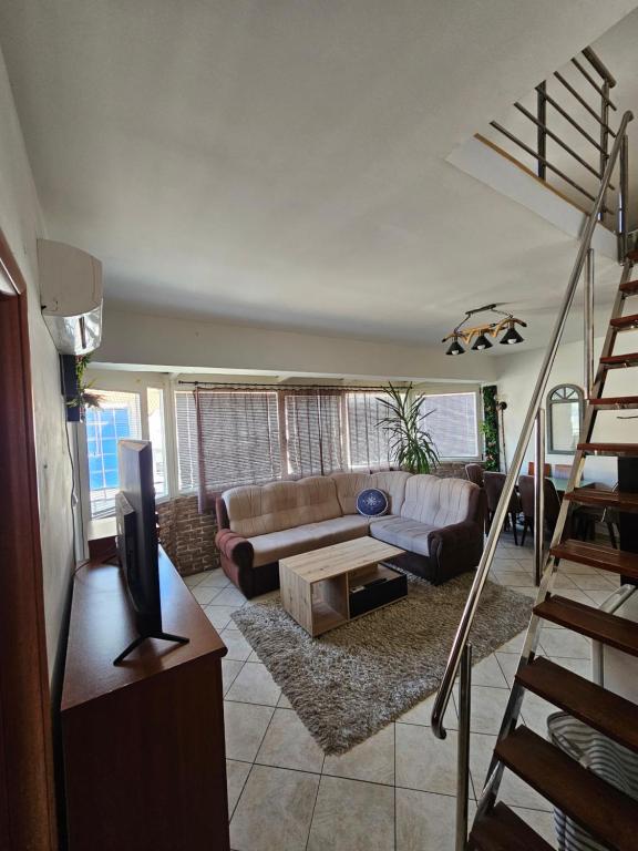 a living room with a couch and a table at Nearby PORTONOVI-Norwegian-village DUPLEX in Đenovići