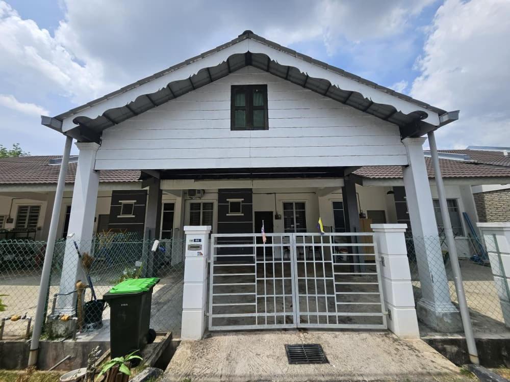 a house with a gate in front of it at Razumi's Homestay 2 in Arau