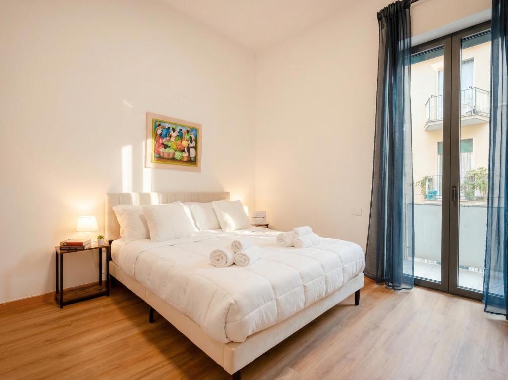 a bedroom with a large white bed with towels on it at Blu Mediterraneo 2 Bedrooms & 2 bathrooms in Bari