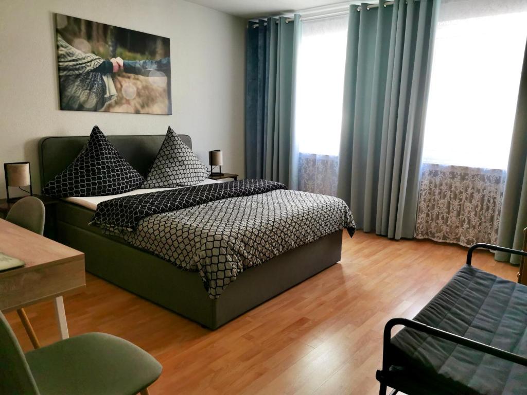 a bedroom with a green bed with pillows on it at Pension Restaurant Luna in Treis-Karden
