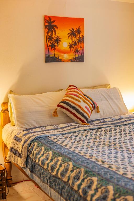 a bedroom with a bed with a pillow on it at The Yellow House By Leela in Patnem