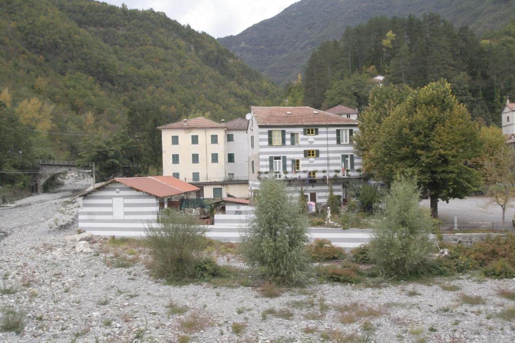 a group of buildings with mountains in the background at B&B Jolly Gorreto in Gorreto