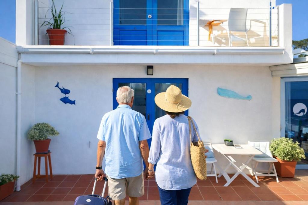 an older couple walking into a house at BlueSky Arniston Boutique Guesthouse in Arniston