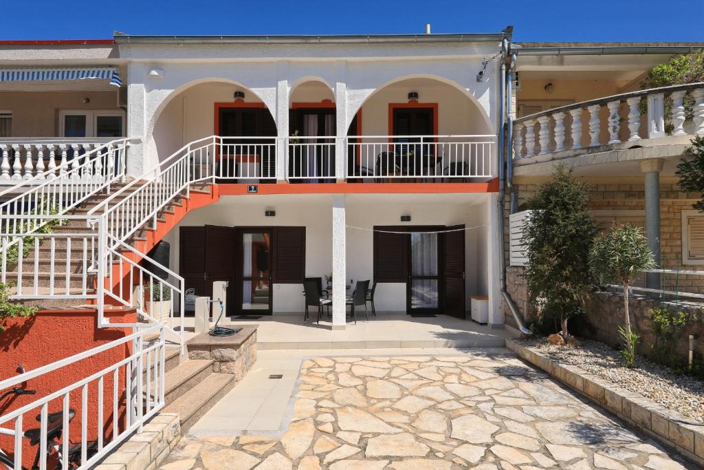 a house with a staircase and a patio at Hibis, No 3 in Starigrad