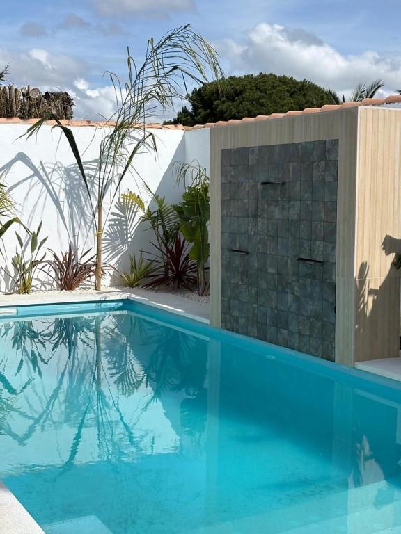 a large blue swimming pool next to a wall at GUACAMAYOS in Cádiz