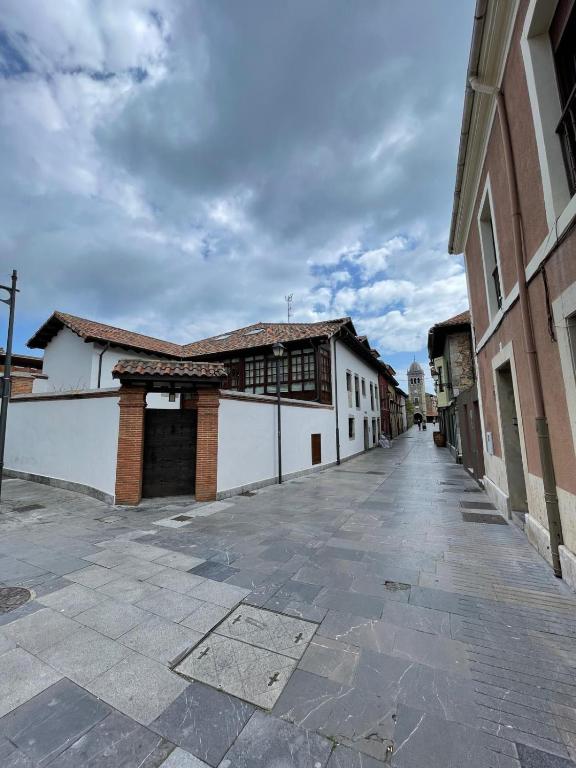 an empty street in a town with buildings at Aticos La Riba in Luanco