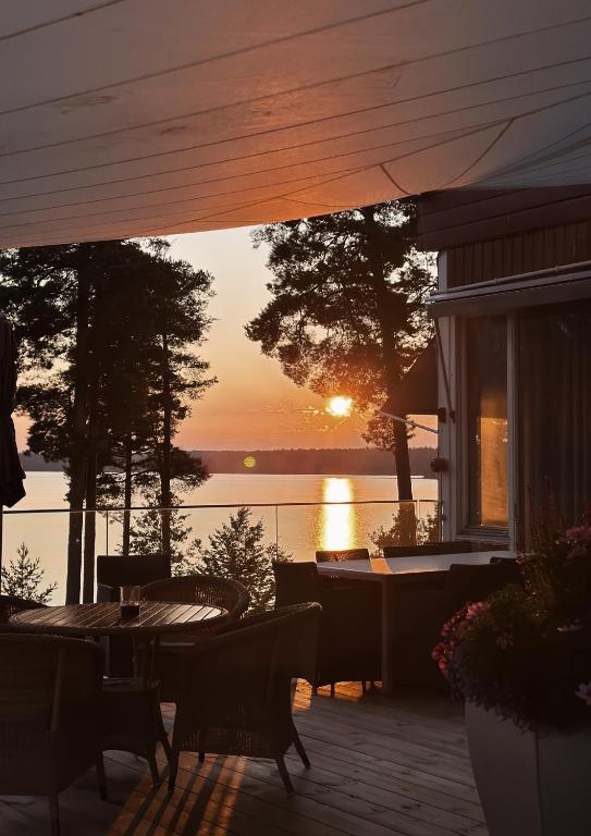 a view of the sunset from the deck of a house at Bommersvik Hotell & Konferens in Järna