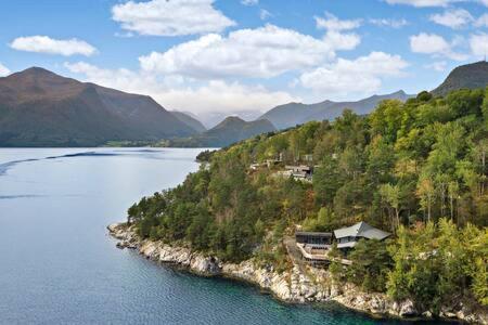 an island in the middle of a large body of water at Torvika Hus in Isfjorden