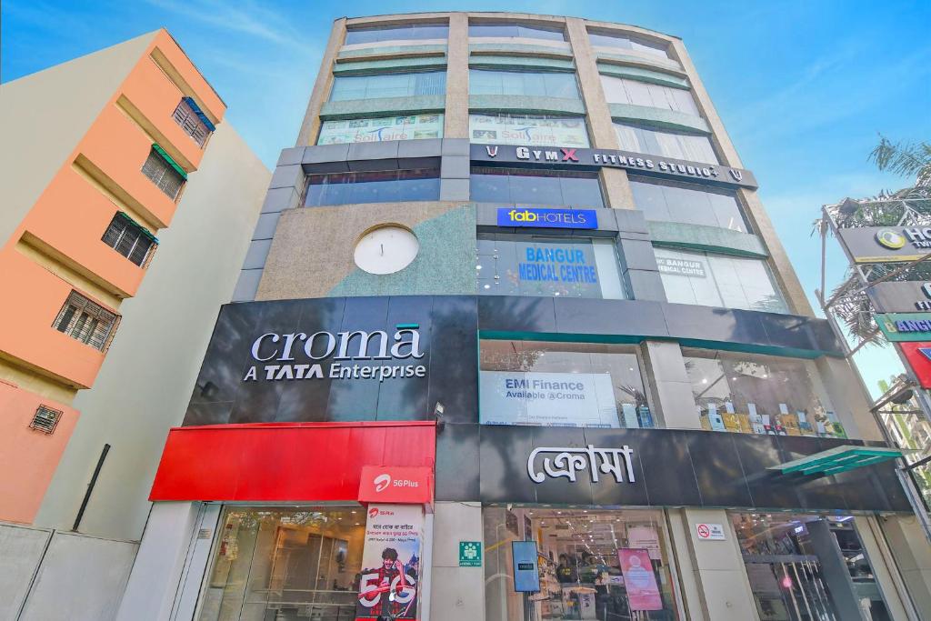 a tall building with a sign on it at FabHotel The Crown Aura in kolkata