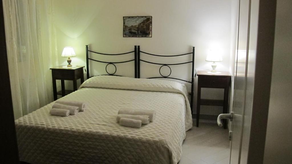 a bedroom with a bed with two towels on it at Iris Chioggia in Chioggia