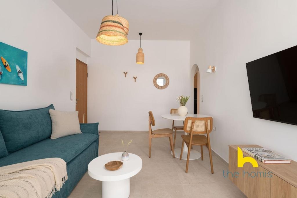 a living room with a couch and a table at Sun-Splashed Top-Floor APT with Seaview and Jacuzzi! in Vari