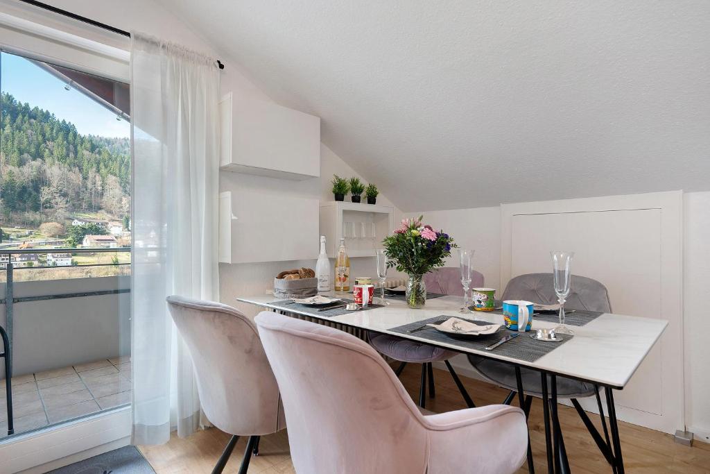 a dining room with a table and chairs and a window at Ferienwohnung Kraft in Bad Wildbad