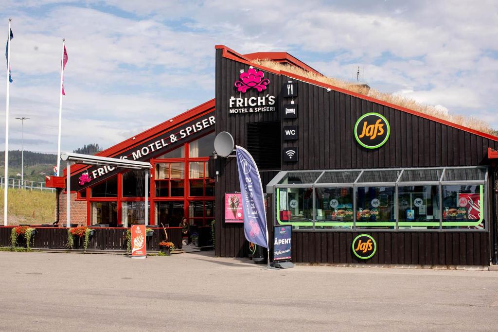 a building with a music store with a sign in front at Frich's Rudshøgda in Ringsaker