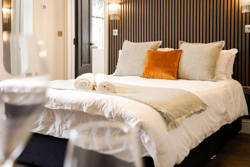 a large bed with towels and pillows on it at Lovely Studio Flat on Bath Road - Flat 10 in Bristol