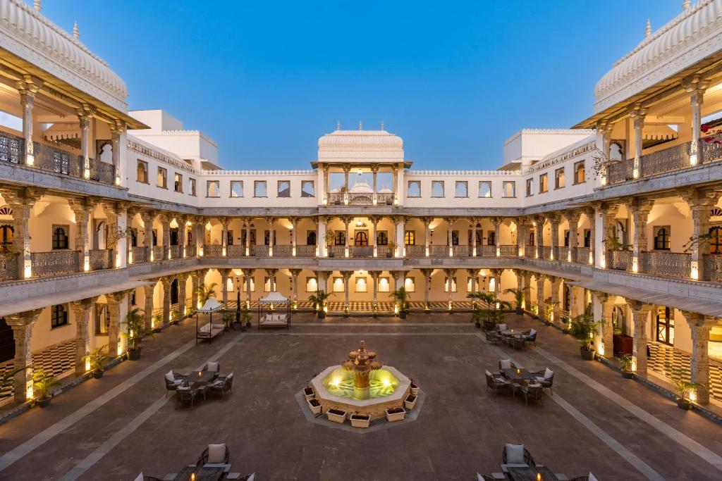 an indoor courtyard of a building with a fountain at lebua Udaipur Daulatgarh in Udaipur