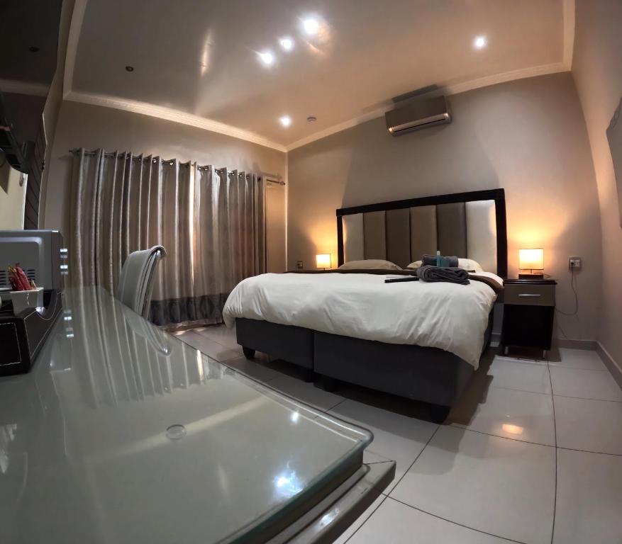 a bedroom with a bed and a bath tub at Viking Guest House in Mahikeng