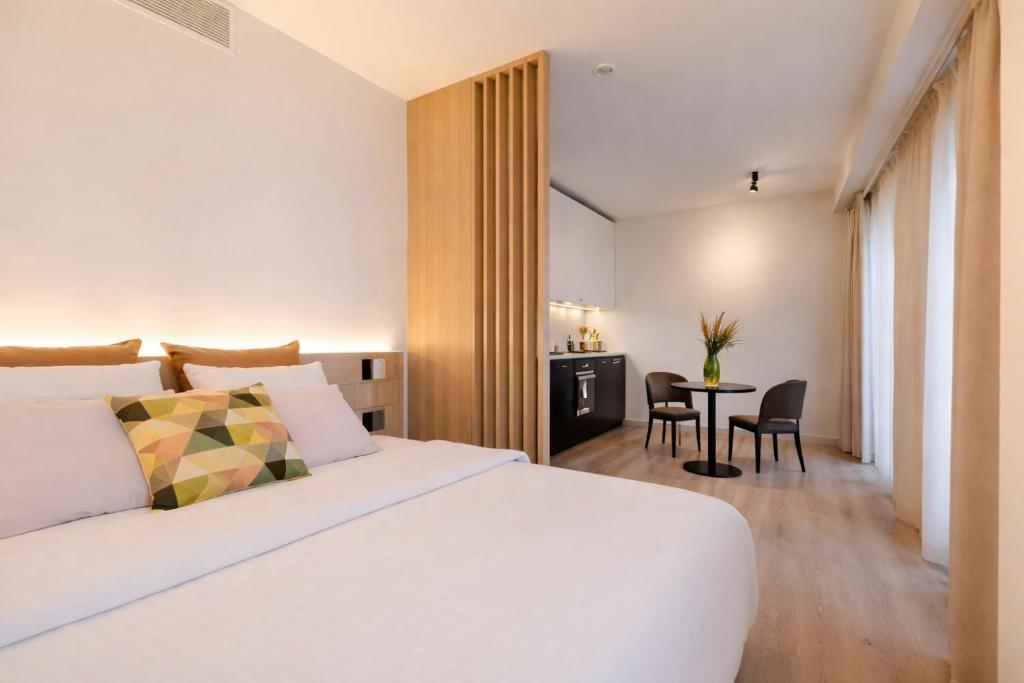 a hotel room with a bed and a table at Stay at Brussels in Brussels