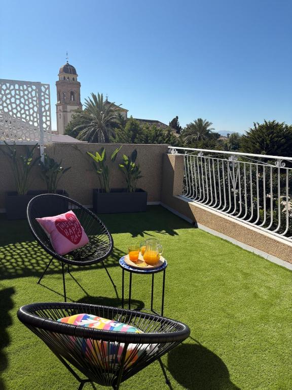 a patio with two chairs and a table with drinks at Apartamento en Lorca Murcia in Lorca