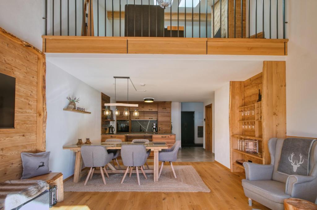 a kitchen and dining room with a table and chairs at Chalet Loferwinkl in Reit im Winkl