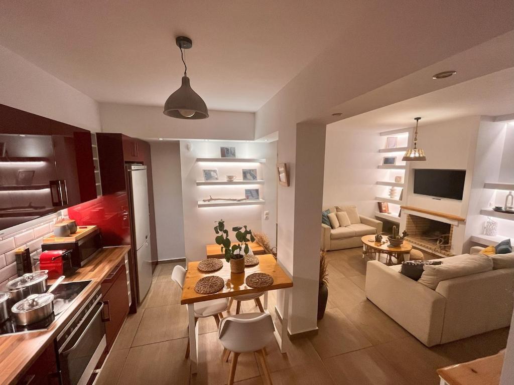 a kitchen and living room with a table and a couch at Harmony garden house in Porto Rafti