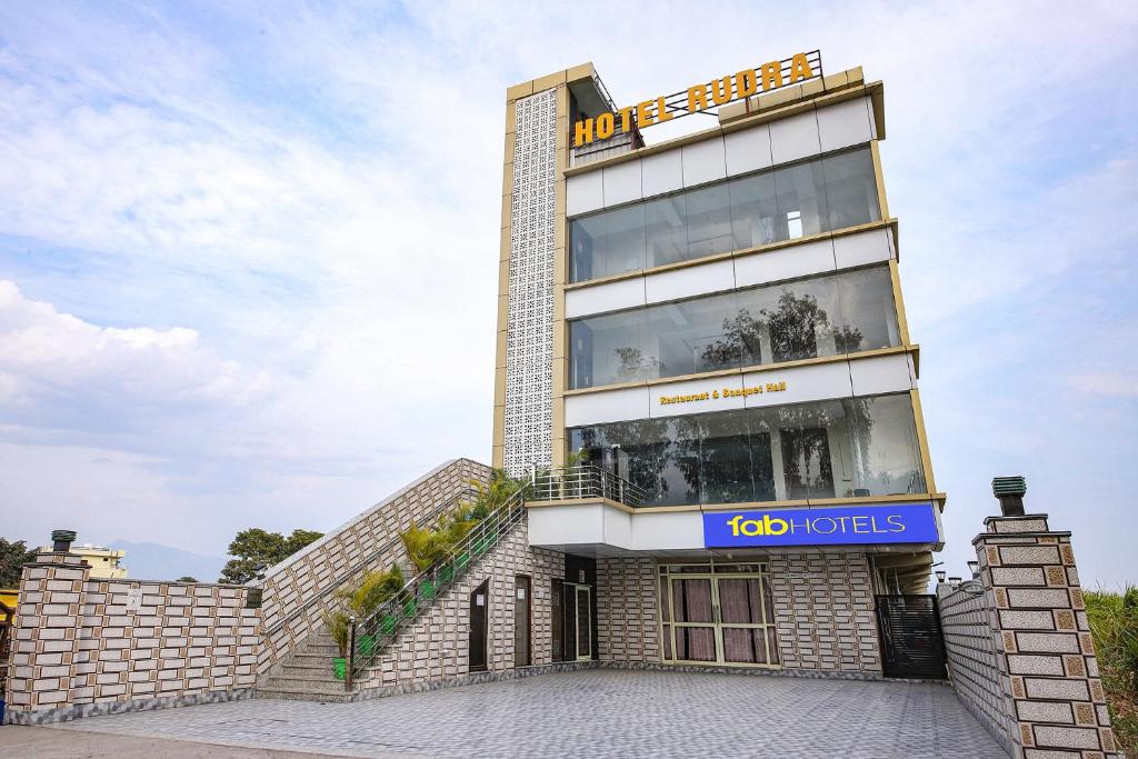 a building with a sign that reads ko hotels at FabHotel Rudra in Dehradun