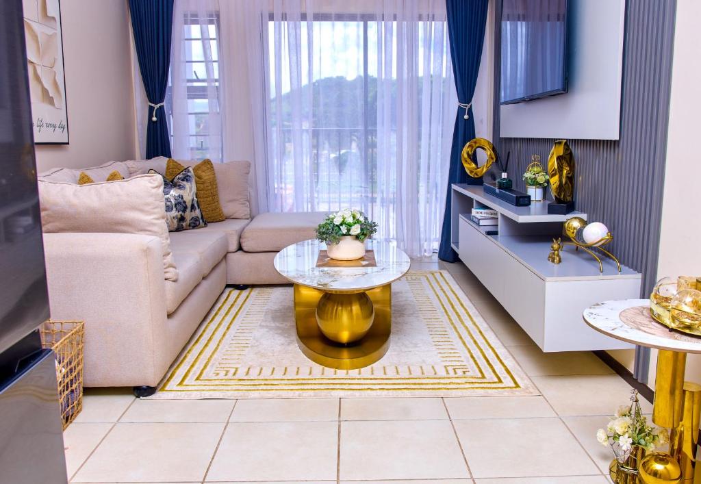 a living room with a couch and a table at Kunashe Apartments in Harare