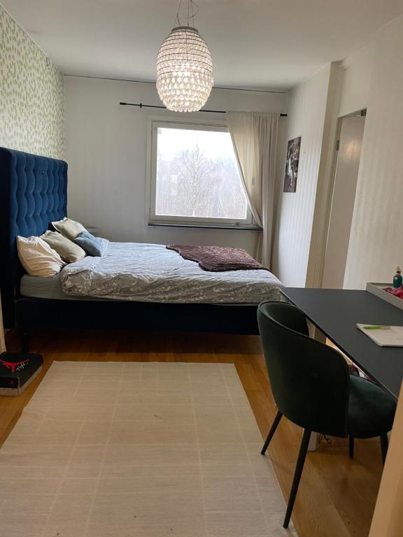 a bedroom with a bed and a desk and a window at Big Room in shared apartment in Kungälv