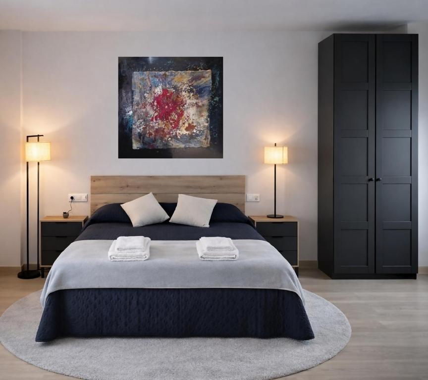 a bedroom with a large bed with two night stands at Apartamento exclusivo Muralla de Lugo 1.1 in Lugo