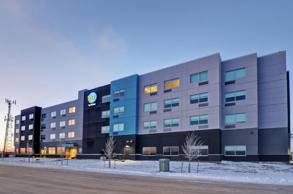 a building with a sign on the side of it at Tru By Hilton Edmonton Windermere in Edmonton
