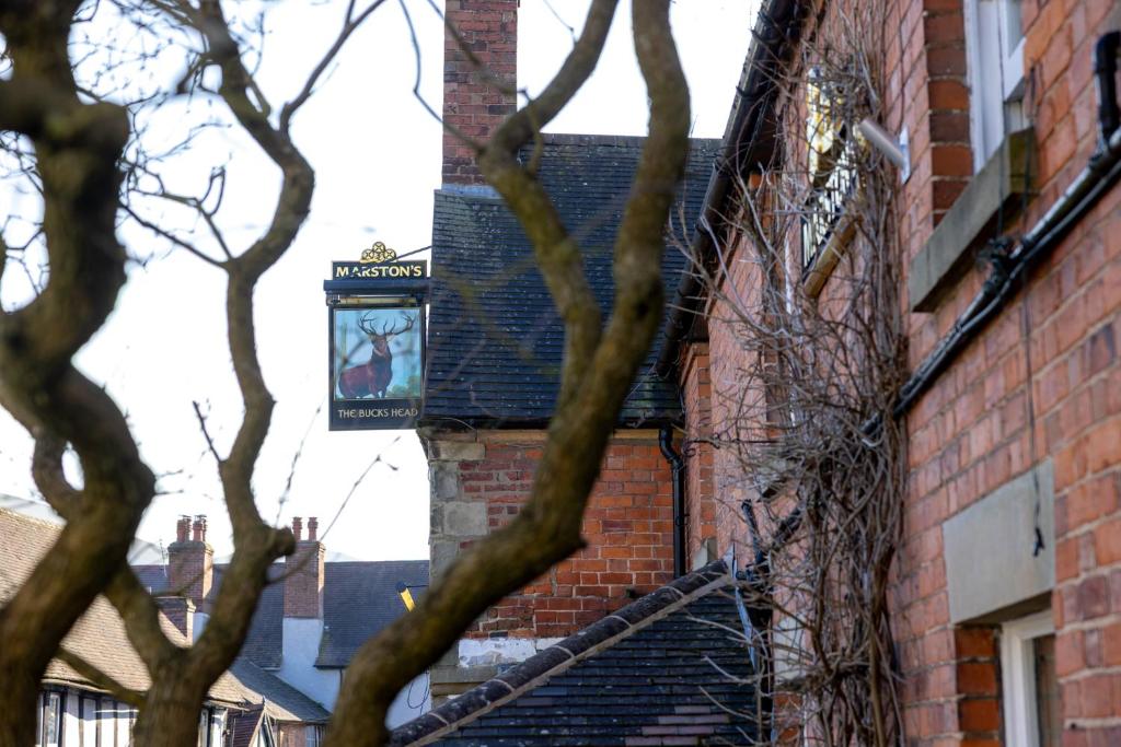 a sign on the side of a brick building at The bucks head in Church Stretton