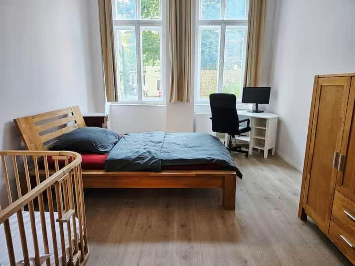 a bedroom with a bed and a desk and window at Studio Appartement without steps and terrace in Görlitz
