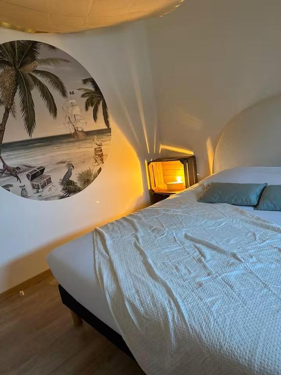 a bedroom with a bed with a painting on the wall at Logement Pirate themed suite with parking in Vesoul