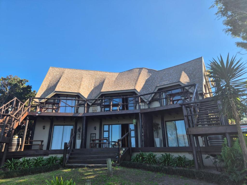 a large house with a tin roof at The Birdhouse Bed & Breakfast #NO Loadshedding #Solar Energy in Gonubie