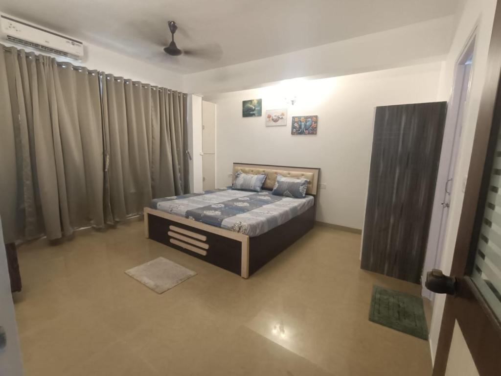 a bedroom with a bed in a room at 1 bhk apartment ruby residency in Canacona
