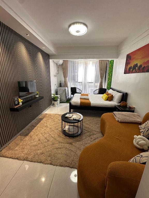 a living room with a bed and a couch at Elite Homes furnished Studio near JKIA in Syokimau