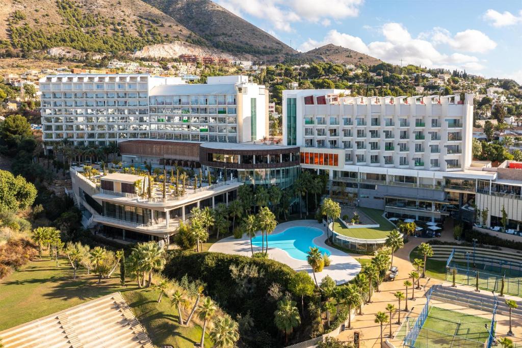 an aerial view of a hotel with a resort at Higuerón Hotel Málaga, Curio Collection by Hilton in Fuengirola