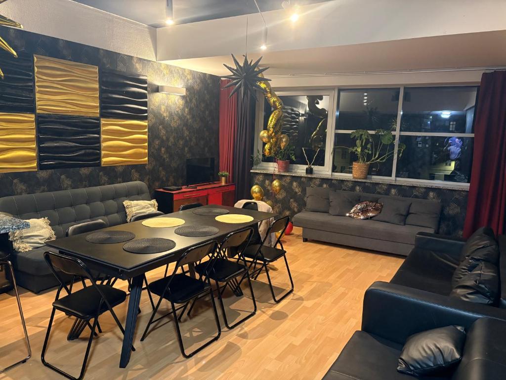 a living room with a table and chairs and a couch at event in Wrocław