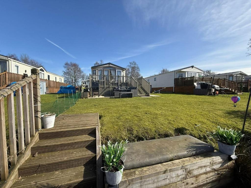 a wooden staircase leading to a yard with houses at Sunset Serenity - 4 Sunset View in Crowle