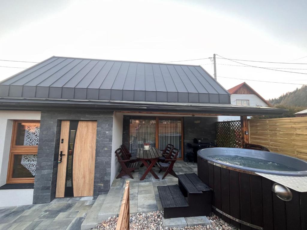 a house with a hot tub on a deck at Przystanek Stodoła in Rajcza