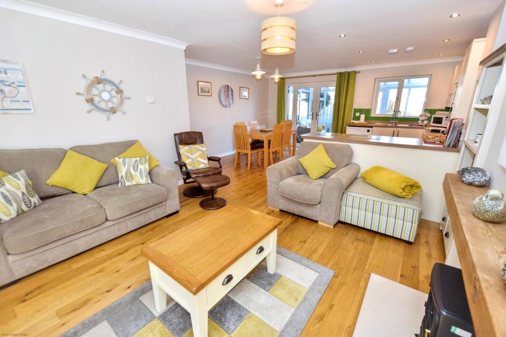 a living room with a couch and a table at 18 Marriotts Way in Sheringham