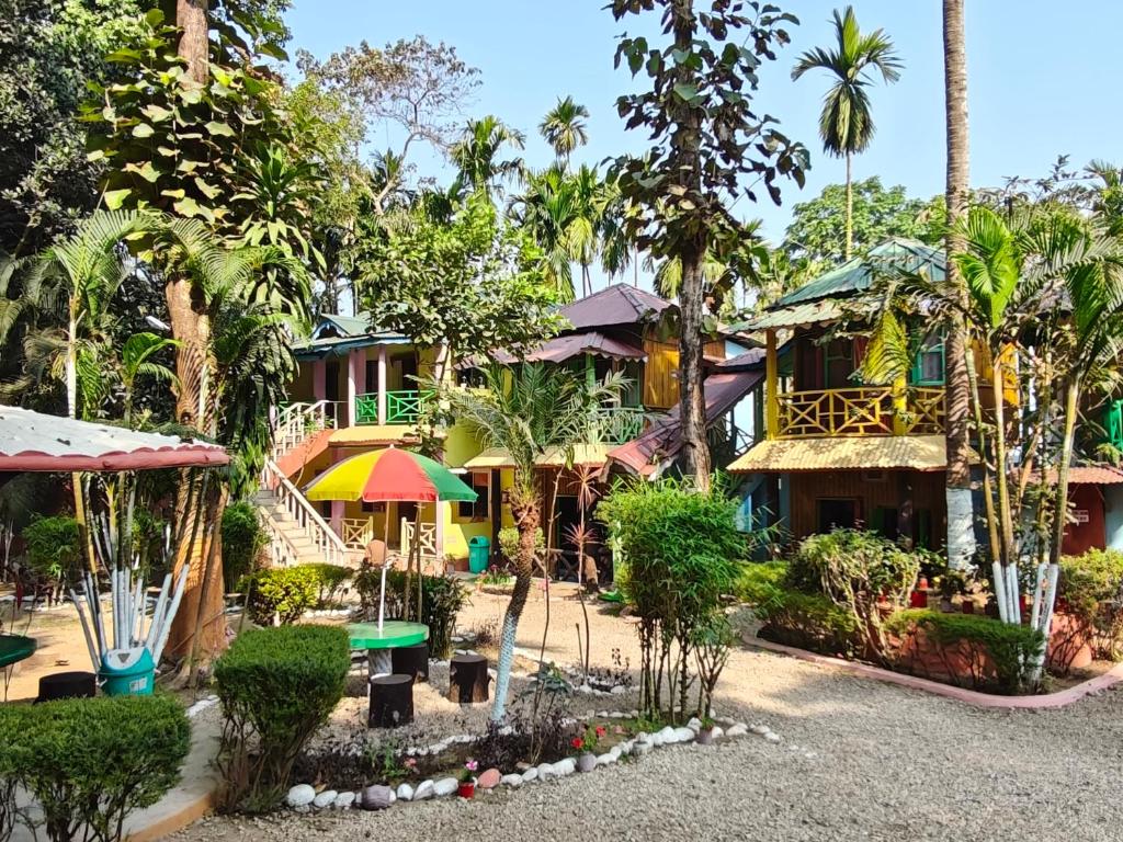 a resort with a lot of trees and buildings at Orchid Resort in Lataguri