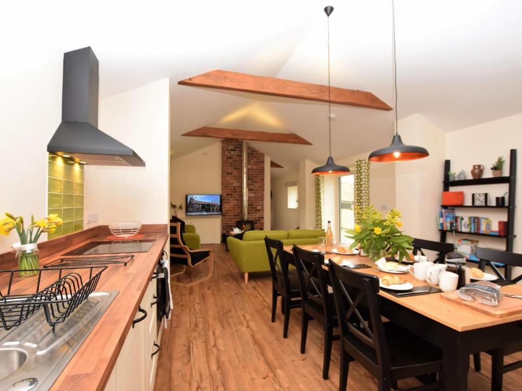 a kitchen and dining room with a long table with chairs at 3 Bed in Alford oc-55963 in Rigsby