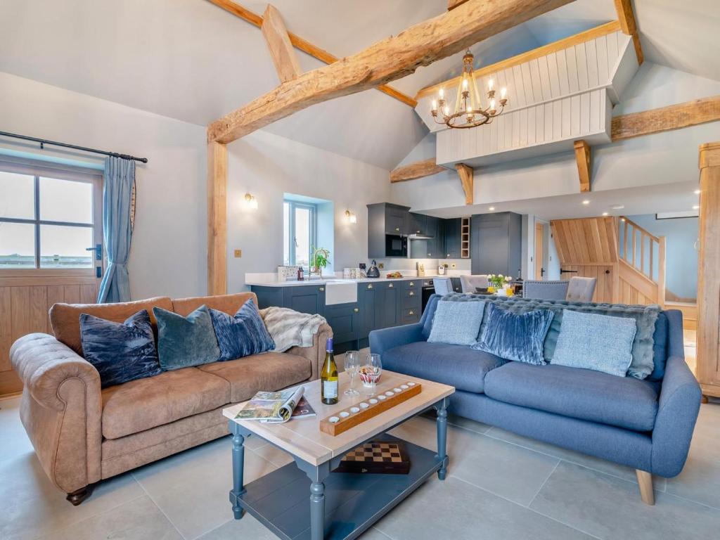 a living room with two couches and a table at 1 Bed in Gloucester oc-95793 in Tirley