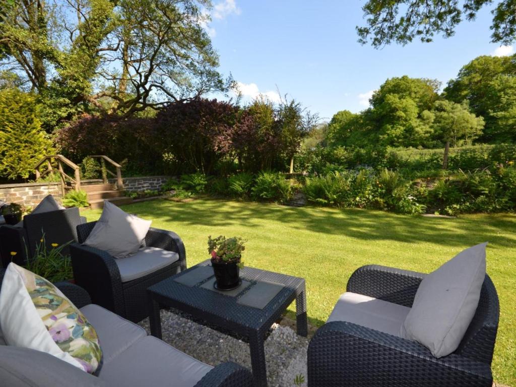 a patio with chairs and a table in a yard at 2 Bed in Llandysul oc-79199 in Felindre