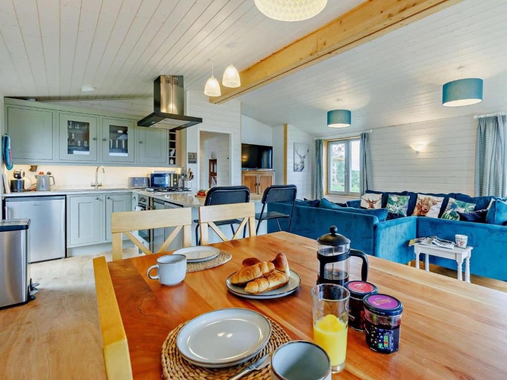 a kitchen and living room with a table with food on it at 4 Bed in Shrewsbury oc-93398 in Leighton